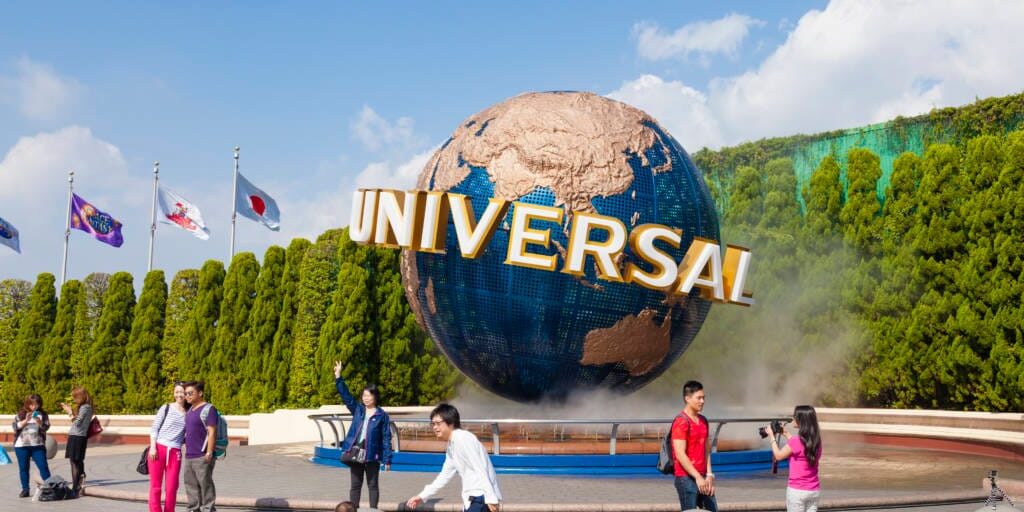 Universal Studios in Osaka, Japan Osaka, Japan - October 27, 2014: View of tourists and Universal Globe outside the Universal Studios Theme Park in Osaka, Japan. The theme park has many attractions based on the film industry.